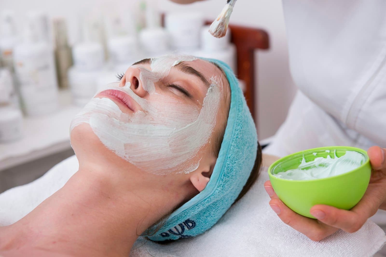 Aesthetician in a calm modern medical spa treatment room, booking high-ticket treatments